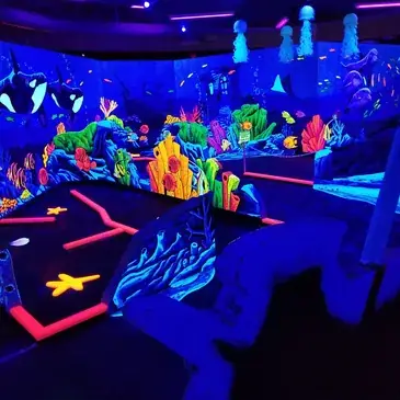Overhead view of the vibrant coral reef and underwater world with orca mural at Imagine 3D Mini Golf