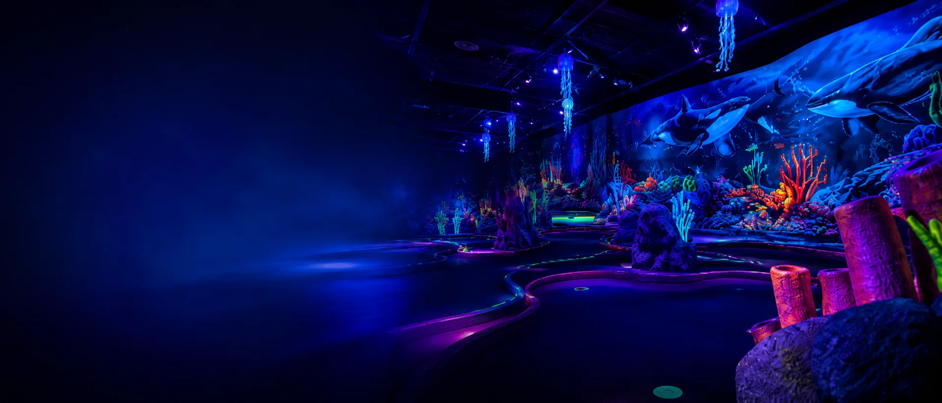 Immersive glowing blacklight mini golf world with neon coral reefs and fantasy environments