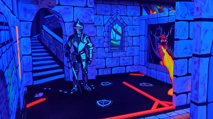 Glowing knight and dragon in the castle fantasy world at Imagine 3D Mini Golf